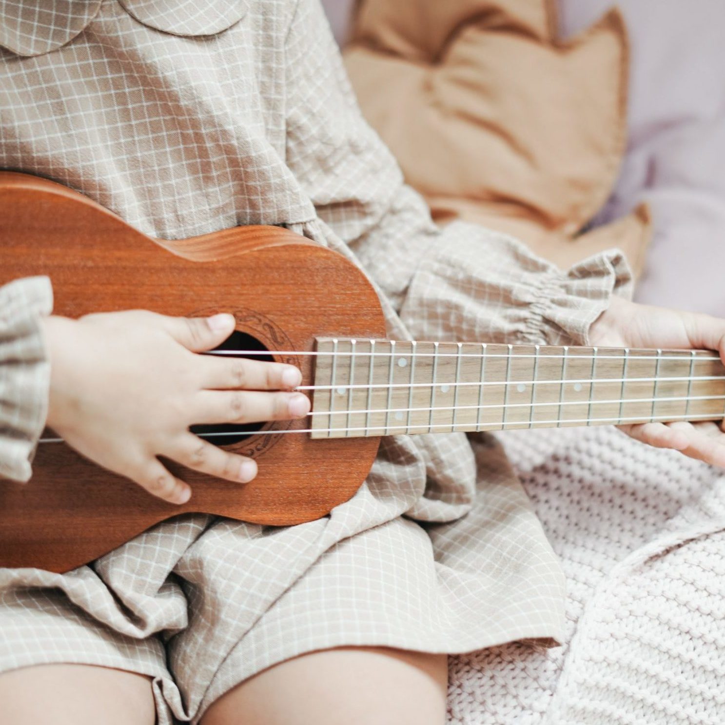 close up of a kid playing a guitar
